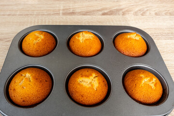 Tasty Almond Cookies on baking grill black tray and on wooden table.