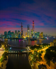 Obraz premium Aerial view of modern city skyline and burning clouds at sunrise in Shanghai