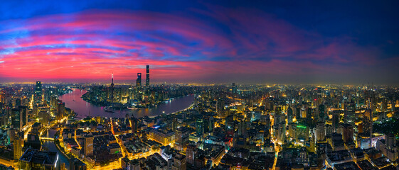 Aerial view of modern city skyline and burning clouds at sunrise in Shanghai