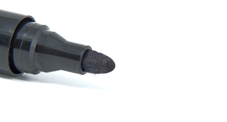 Close-up of black permanent marker with white background for office and art use