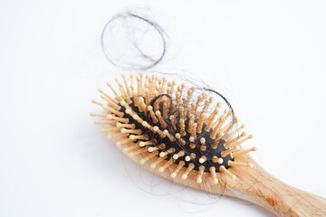 Asian woman have problem with long hair loss attach to comb brush.