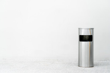 Stainless steel bins on a white wall. Copy space for text.
