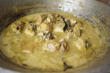Selective focus of Opor Ayam (Indonesian chicken curry) in the making, a popular traditional indonesian dish