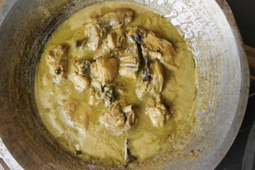 top view of Opor Ayam (Indonesian chicken curry) in the making, a popular traditional indonesian dish