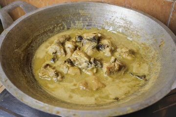 Selective focus of Opor Ayam (Indonesian chicken curry) in the making, a popular traditional indonesian dish