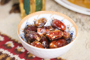 Selective focus of delicious dried dates (Kurma) in the bowl. Special Dish Served during Ramadan and Eid Mubarak