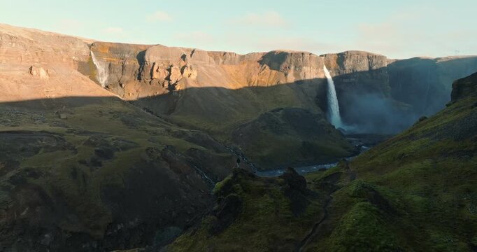 Man Viewing Haifoss Waterfall From Rocky Outcrop