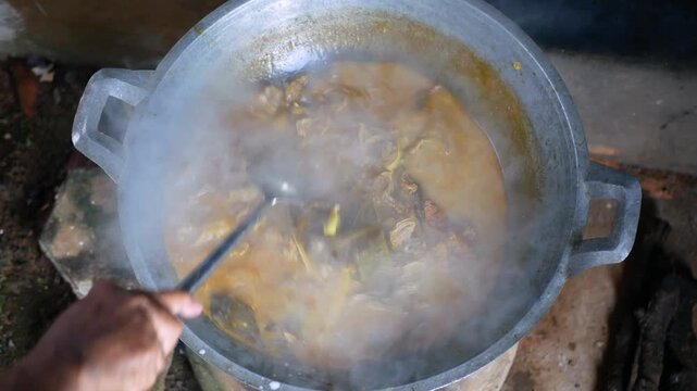 The process of cooking Rendang on a Earthenware furnace or tungku gerabah is Indonesian local stove made from clay, Rendang is a popular traditional indonesian dish