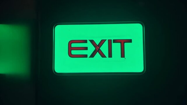 ivid Green Exit Sign Against Dark Background
