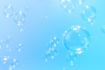 Beautiful Transparent Shiny Soap Bubbles Floating in The Air. Celebration Festive Backdrop. Freshness Soap Suds Bubbles Water. Abstract Blue Textured Background.