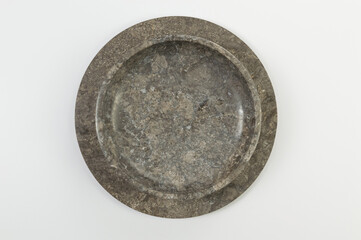Top view of brown marble tray and plate on white background. Food presentation, stone tray. Copy space, flat lay.