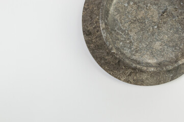 Top view of brown marble tray and plate on white background. Food presentation, stone tray. Copy space, flat lay.