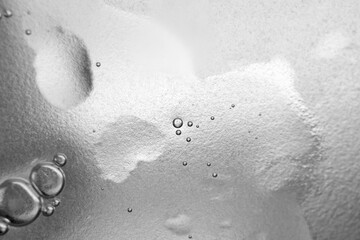 The surface of the cosmetic product has bubbles. blurred background. soft focus