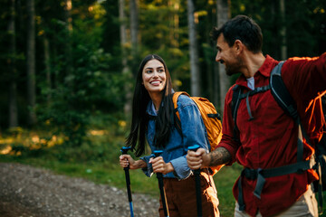 Shot of a happy young couple going for a romantic walk in the woods