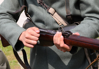 Soldier with the historic Italian army uniform from the First World War hand loading an old rifle