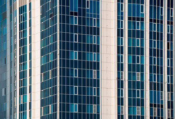 Fototapeta premium many windows and walls facade of a modern skyscraper without people