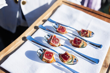 bite sized seared tuna served on individual spoons at event