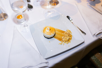 Beautiful pavlova dessert garnished with caramel on square white plate