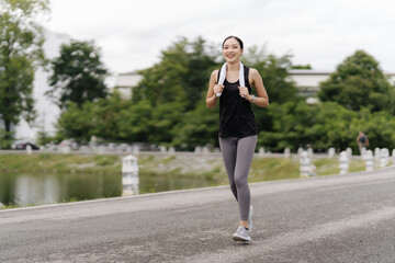 Asian girl jogging
Exercise in the morning with headphones on and a happy smile.