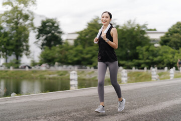 Asian girl jogging
Exercise in the morning with headphones on and a happy smile.