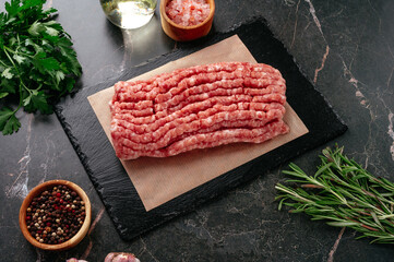 ground beef on a black stone board