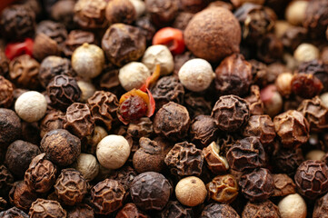 macro photo of black and white pepper.