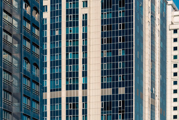 many windows and walls facade of a modern skyscraper without people