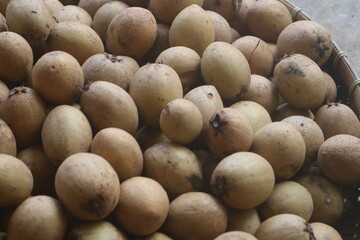 sapodilla fruit with a hand-woven bamboo background. sweet tasting fruit.