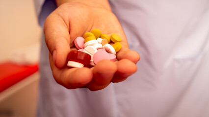 Close-Up of a Hand Filled with Various Pills and Tablets: Pharmaceutical Promotions, Healthcare Marketing, and Medical Educational Content.