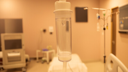 Close-up of the IV in the hospital room. Droplets of serum. Medical intervention.