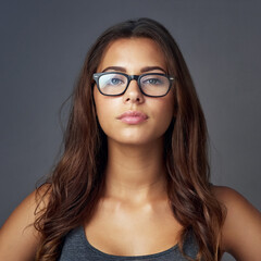 Eye care, woman and face on studio for confidence, attitude and designer optometry brand. Female person, glasses and portrait on dark background with prescription lens, new frames and aesthetic