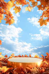 Empty golden product display podium surrounded by autumn leaves against blue sky with clouds 