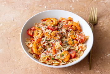 Farfalle pasta with shrimps, tomatoes and cheese. Healthy eating. Italian food.