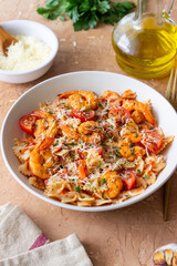 Farfalle pasta with shrimps, tomatoes and cheese. Healthy eating. Italian food.