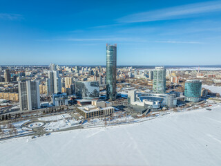 Fototapeta premium Yekaterinburg city with Buildings of Regional Government and Parliament, Dramatic Theatre, Iset Tower, Yeltsin Center, panoramic view at winter sunset.