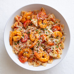 Farfalle pasta with shrimps, tomatoes and cheese. Healthy eating. Italian food.