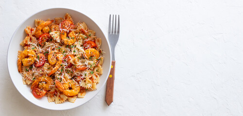 Farfalle pasta with shrimps, tomatoes and cheese. Healthy eating. Italian food.
