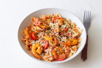 Farfalle pasta with shrimps, tomatoes and cheese. Healthy eating. Italian food.