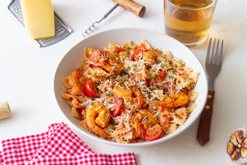 Farfalle pasta with shrimps, tomatoes and cheese. Healthy eating. Italian food.