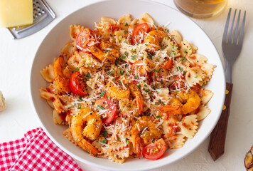 Farfalle pasta with shrimps, tomatoes and cheese. Healthy eating. Italian food.