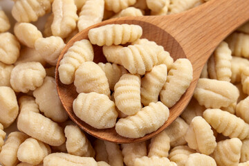 Light and fluffy gnocchi in wooden spoon. Traditional Italian cuisine ingredient
