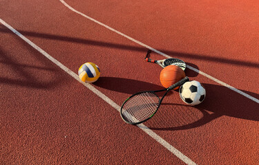 Set of sport equipment, rackets and tennis balls soccer and basketball balls