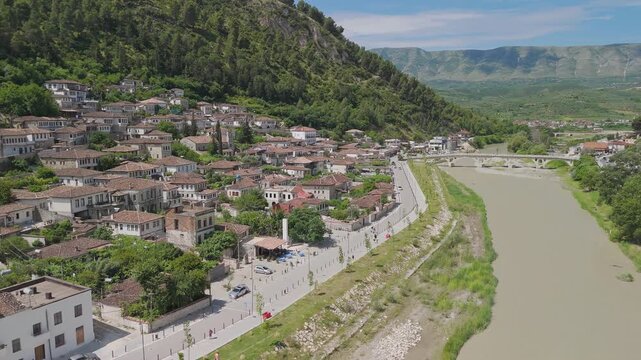 Drone shot of Berat cityscape on the Osum River in central Albania surrounded by mountains and hills
