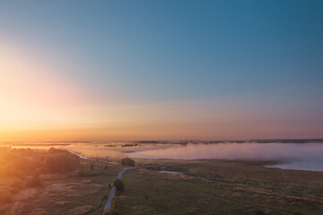 Breathtaking and Stunning Sunrise Over a Misty Landscape that is Bursting with Vibrant Colors