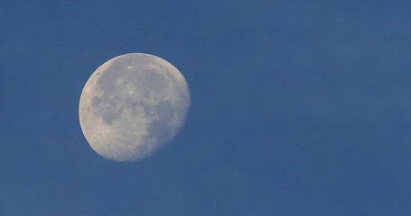 Full moon over blue sky