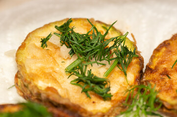 fried zucchini slices sprinkled with chopped parsley