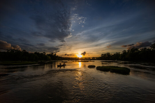 Couple canoeing on a river.