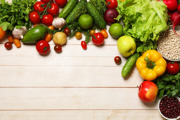 Different vegetarian products on light wooden table, top view. Space for text