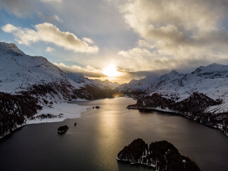 Dramatic sunset over the lake Sils in winter in the Engadine valley near Silvaplana and St Moritz...