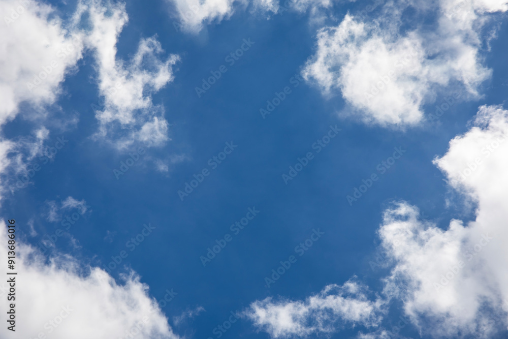 Wall mural blue sky background and white clouds soft focus, space in the middle, horizontal shape.